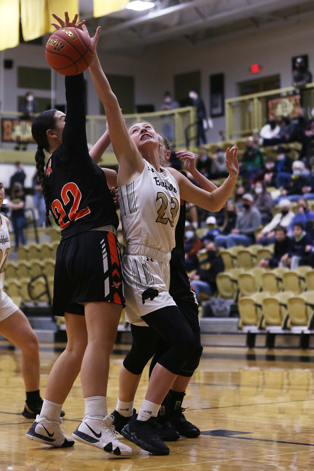 Ava Wagner stretches in an attempt to steal a rebound from Worland senior Ajiah Montoya